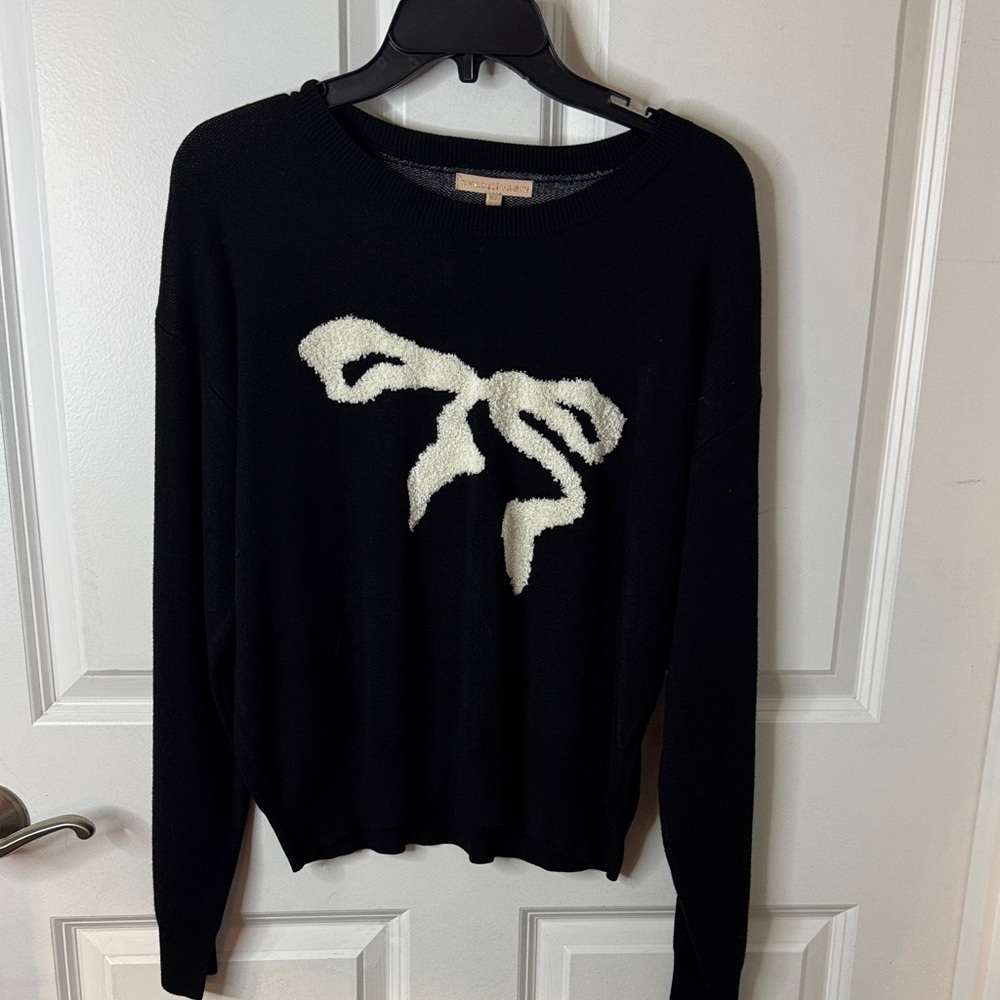 Evolutionary Black Sweater with White Bow Design